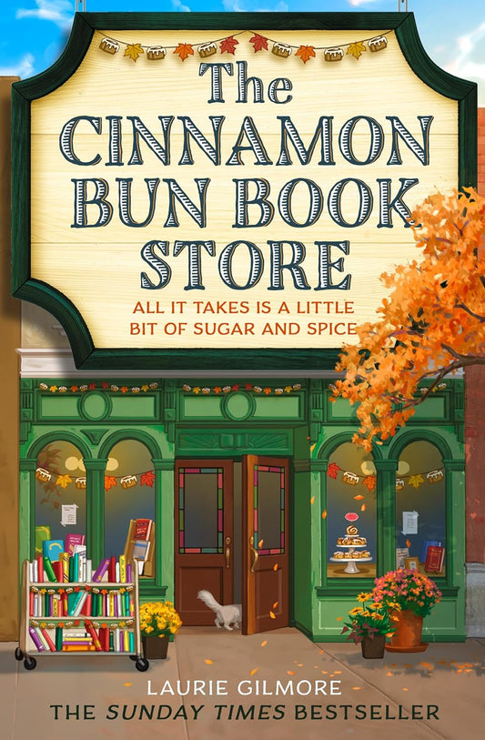 Book cover of 'The Cinnamon Bun Book Store' with a store facade and autumn elements.