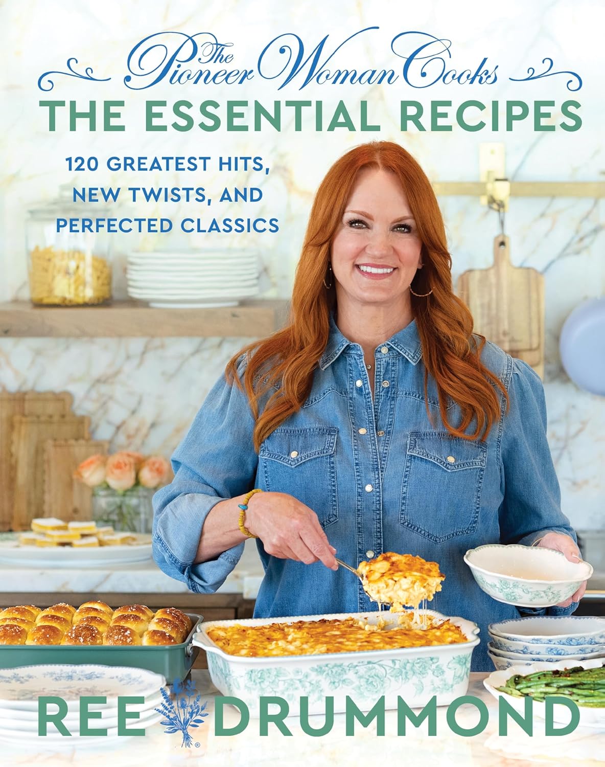 Cookbook cover featuring a woman holding a dish with food, surrounded by baked goods.