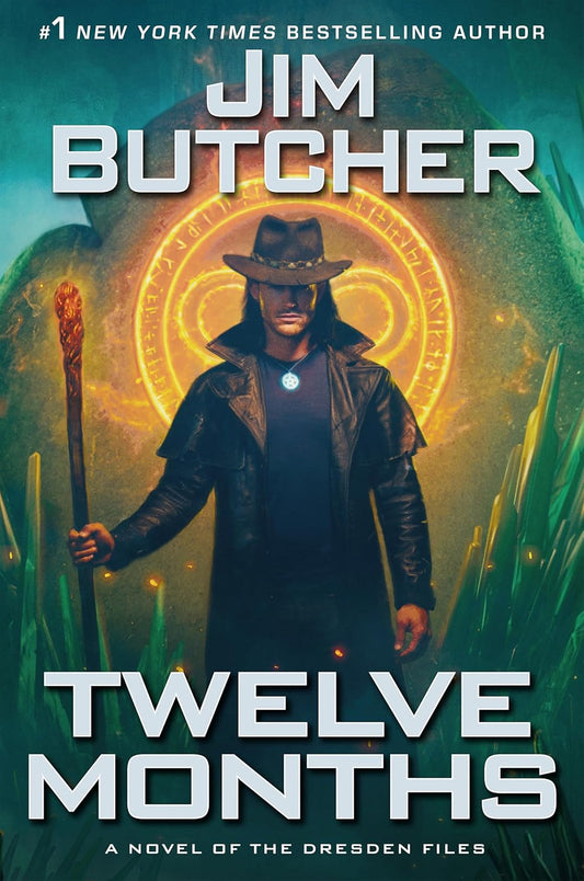 Book cover of 'Twelve Months' by Jim Butcher featuring a character holding a staff with a glowing emblem.