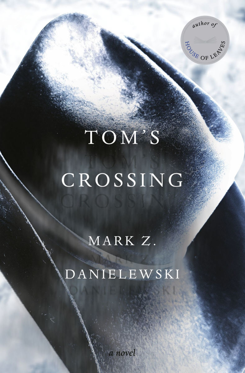 Book cover of 'Tom's Crossing' by Mark Z. Danielewski with a close-up of a face wearing a helmet.